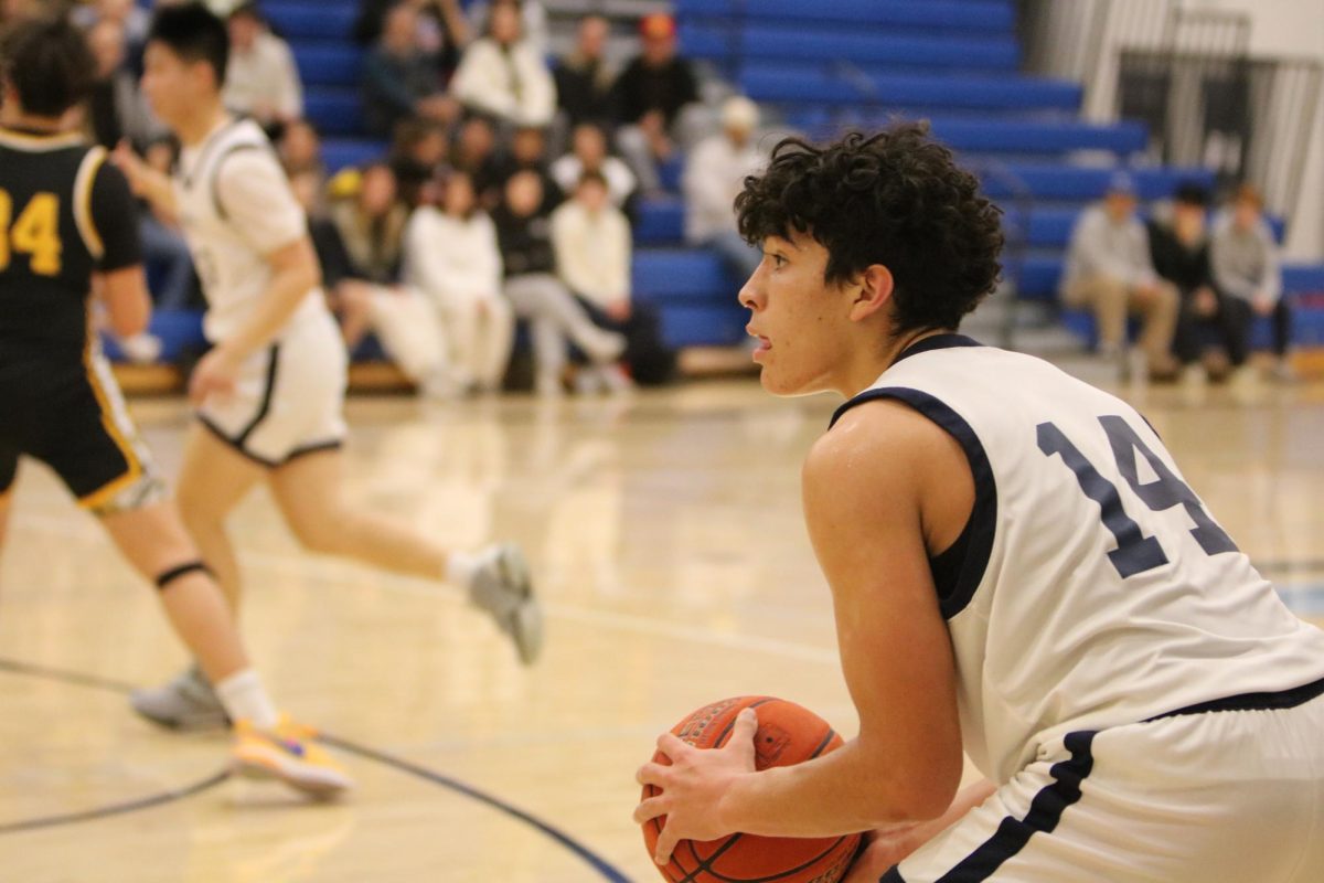 Owen Brown '25 in the middle of a basketball game for Urban. 